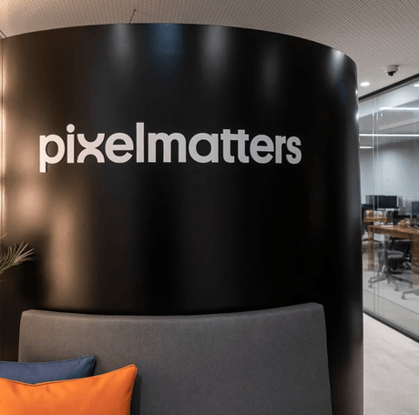 The office entrance featuring the Pixelmatters logo on a curved black wall